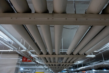Poster - Underground piping service system in an office building car parking delivering fresh water, sewage, electrical and gas to the offices and shop floors above