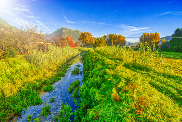 Canvas Print - Tuscany landscape with small creek in autumn season, foliage colors