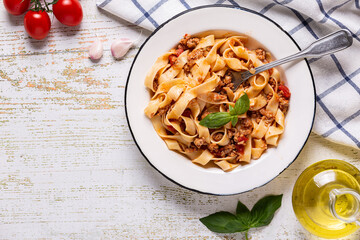 Wall Mural - Traditional italian pasta bolognese on a white plate on a wooden background