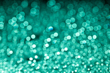 Abstract green bokeh texture on green background