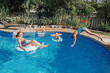 © anoushkatoronto - Mother with daughters children relaxing in swimming pool on home backyard. Sisters siblings diving and having fun in swimming pool together. Summer outdoors water activity for family and kids.