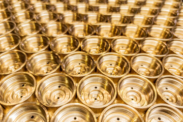 Wall Mural - an abstract perspective industrial close-up background of shiny brass metal threaded hexagonal fitting parts