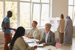 © Seventyfour - Wide angle view at multi-ethnic group of people voting at polling station decorated with American flags, copy space