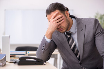 Young male employee working in the office