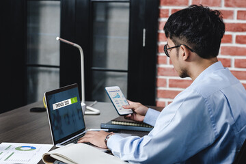 Aufkleber - asian businessman looking business plan and forecasting 2021 trednds with laptop on desk  at office.digital workflow online business lifestyle concept