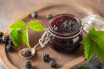 Wall Mural - Blackberry  jam preserves  in a jar and fresh berries on the table.