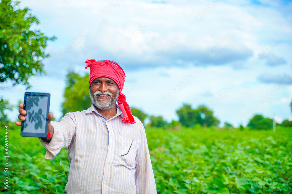 Indian farmer Showing a mobile screen at agriculture field Stock Photo ...