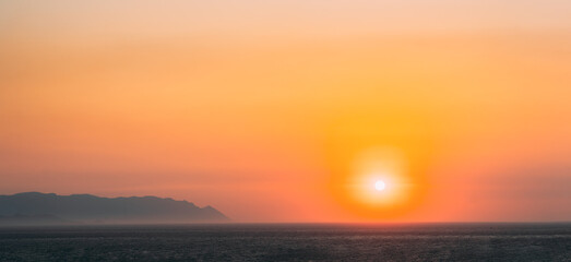Wall Mural - Aegean Sea. Evening Sun Sunshine Above Sea. Natural Sunset Sky Warm Colors. Panorama, Panoramic View Seascape