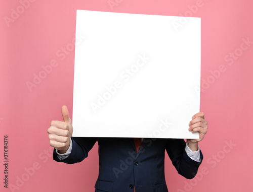 Cuadros en Lienzo elegant businessman hiding behind white empty board