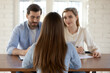 © fizkes - Rear view two hr managers interviewing young woman candidate, sitting at table in office, businessman and businesswoman recruiters employers asking questions, employment and hiring concept