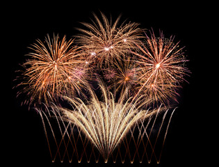 golden fireworks exploding in the night sky on new year's eve