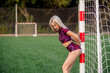 © Maria - Beautiful young woman in sportswear stands near the soccer goal