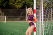 © Maria - Beautiful young woman in sportswear stands near the soccer goal