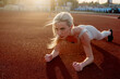 © Maria - Beautiful blonde doing exercises in training at the stadium in summer