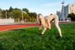 © Maria - Beautiful blonde doing exercises in training at the stadium in summer