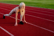 © Maria - Beautiful young blonde starts running a treadmill in the stadium