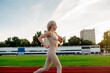 © Maria - Beautiful young blonde woman runs on a treadmill in the stadium