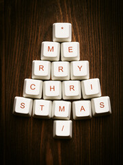 Wall Mural - Christmas tree cut out from paper on a wooden background