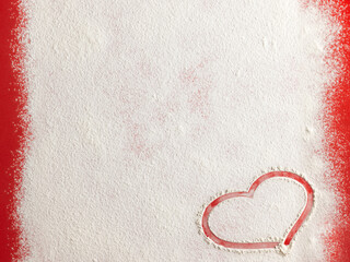 Wall Mural - Valentine love red heart shape made of flour on red background. Closeup.Christmas card.