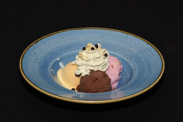 Canvas Print - Closeup shot of delicious ice cream dessert on a blue plate