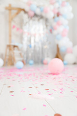 Wall Mural - Gender party decorations - gifts, toys, balloons, garland and figure for little baby party on a white wall background. Soft focus.