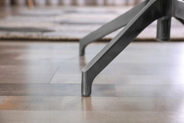 Modern office chair on wooden floor, closeup