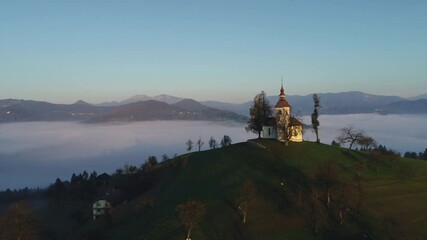 Wall Mural - Aerial view of Saint Tomas church, Slovenia on sunset