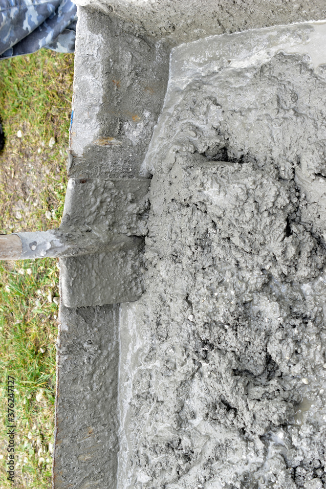 Mixing cement in the muld with shovels for construction Stock Photo ...