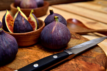 Wall Mural - Black figs with a wooden background