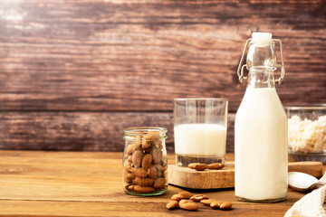 Wall Mural - Almond milk. Healthy homemade, blended almond milk bottle with glass of fresh milk. Rustic background. Copy space.