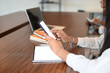 © Prathankarnpap - Cropped image female holding mockup smartphone on long table in meeting room.