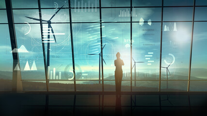 Wall Mural - business woman in a large room in front of a virtual data array and wind farms.