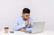 © khosrork - Please, be quiet! Strict bossy man sitting office workplace, asking for silence while talking video call on laptop, keeping finger on lips and hushing. indoor studio shot isolated on white background