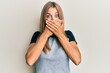 © Krakenimages.com - Young blonde woman wearing casual clothes shocked covering mouth with hands for mistake. secret concept.