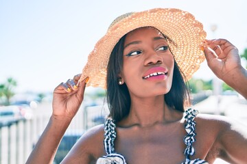 Young african american woman on vacation smiling happy walking at street of city