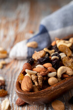 Nut Mix In A Wooden Bowl On A Light Rustic Wooden Table, Close Up, Selective Focus, Catalogue Photo