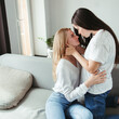 © Vadym - Love, care, human relationships. Lgbt lesbian couple cuddling in living room
