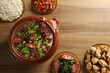 Feijoada, Brazilian food on wooden background. Top view with space for text