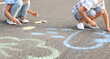 © Pixel-Shot - Little children drawing with chalk on asphalt