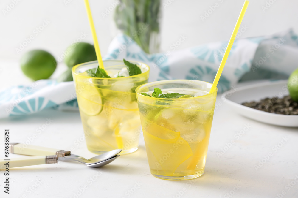 Cups of tasty cold ice tea on table