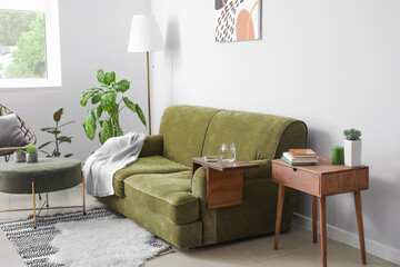 Armrest table on sofa in interior of room