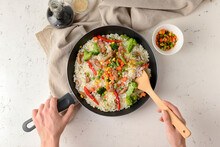Woman Cooking Tasty Fried Rice, Top View