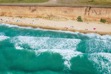 Wall Mural - Sand beach with turquoise water. Aerial view of people on the beach. Vacation travel and relax concept