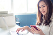 © themorningglory - Successful happy girl manager in her own office working with laptop