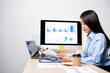 © Orathai - Asian women sit at their desks and calculate financial graphs showing results about their investments, plan a successful business growth process