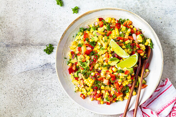 Wall Mural - Mexican corn salad in white plate, top view, copy space. Mexican food concept.