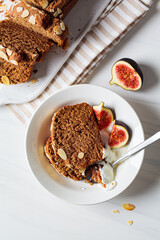 Wall Mural - Portion of nut-fruit bread with yogurt and figs. Vegan banana bread, white background.