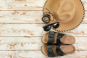 Male beach accessories on white wooden background