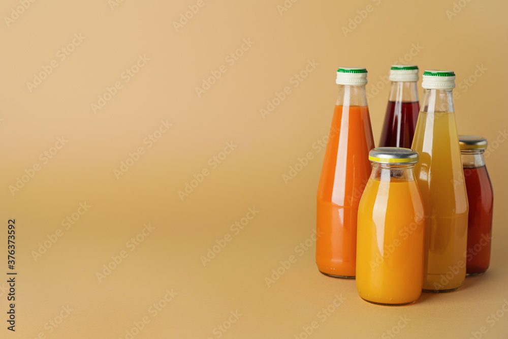 Bottles of juices on color background