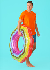 Sticker - Young man with inflatable ring on color background